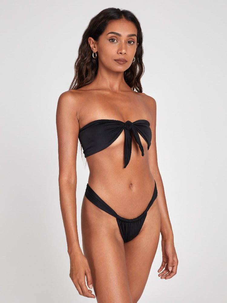 Salty Nips' Aria Bandeau in Onyx: a front-tie bikini with Brazilian bottoms. Adjustable, hand-finished, and ultra-comfortable, it's the essence of summer chic.