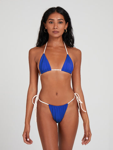 Salty Nips' Alysia Esra Micro String Bikini in hyper blue and cream. Our bestseller, with adjustable design and signature ruching for a seamless, comfortable beach look.