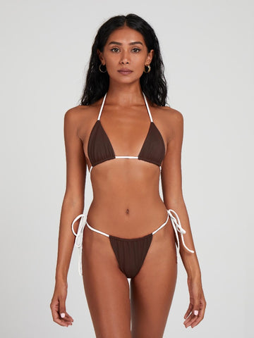 Salty Nips' Alysia Esra Micro String Bikini in coco and cream, our top-selling set. Adjustable, hand-finished, and tailored for a perfect fit, it's the epitome of beach chic.