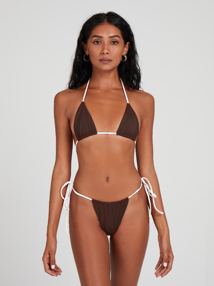 Salty Nips' Alysia Esra Micro String Bikini in coco and cream, our top-selling set. Adjustable, hand-finished, and tailored for a perfect fit, it's the epitome of beach chic.