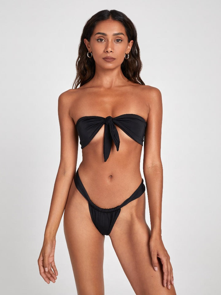 Salty Nips' Aria Bandeau in Onyx: a front-tie bikini with Brazilian bottoms. Adjustable, hand-finished, and ultra-comfortable, it's the essence of summer chic.