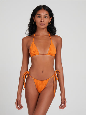 SaltyNips' Alysia Micro Bikini in Tangerine Orange: our top-seller. Fully adjustable with signature ruching, it's the ultimate beach must-have.